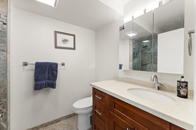 bathroom featuring tile floors, large vanity, and toilet