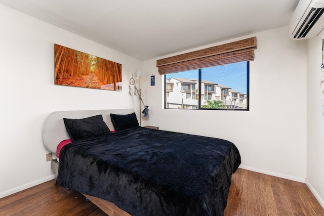 bedroom featuring dark hardwood / wood-style floors and a wall mounted air conditioner