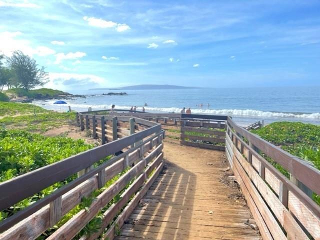 view of community featuring a beach view and a water view