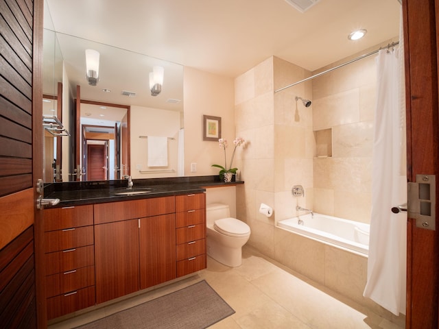 full bathroom with tile patterned flooring, vanity, shower / tub combo, and toilet