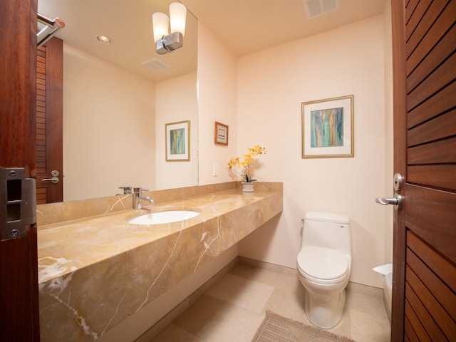 bathroom with tile patterned flooring, toilet, and sink