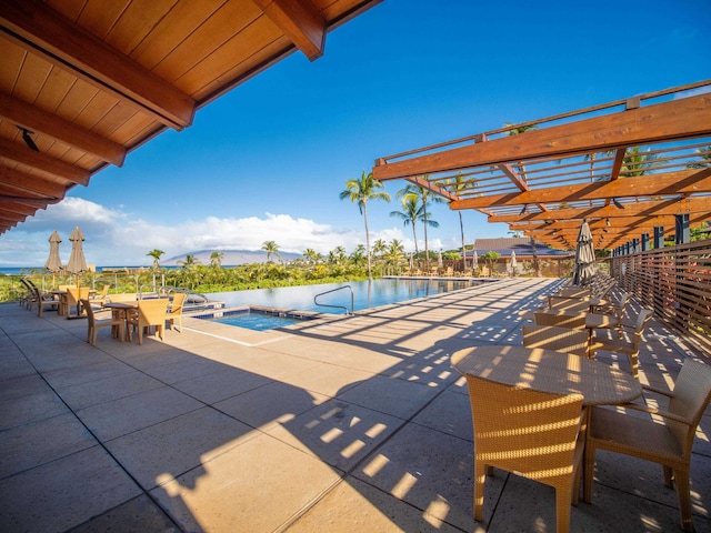 view of pool with a pergola and a patio area