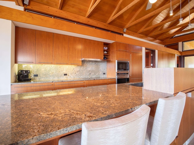 kitchen with appliances with stainless steel finishes, lofted ceiling with beams, stone countertops, and wood ceiling