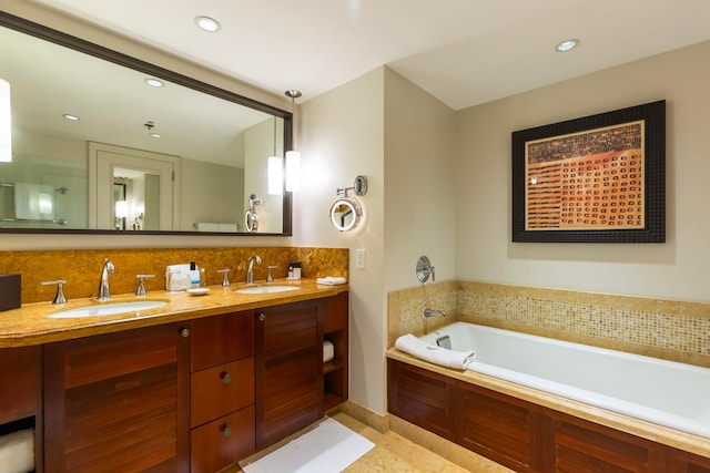 bathroom with backsplash, vanity, and a bath