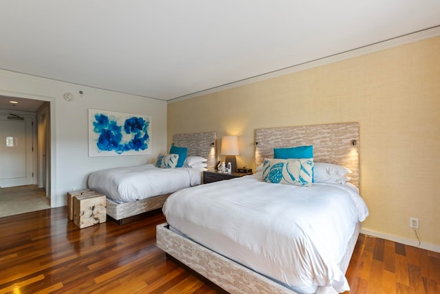 bedroom featuring crown molding and dark hardwood / wood-style flooring