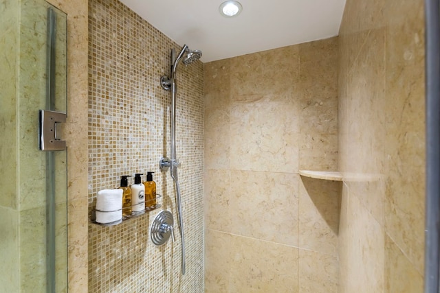 bathroom featuring a shower with shower door