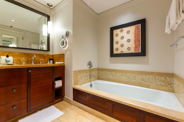 bathroom featuring tile patterned floors, vanity, a tub, and crown molding