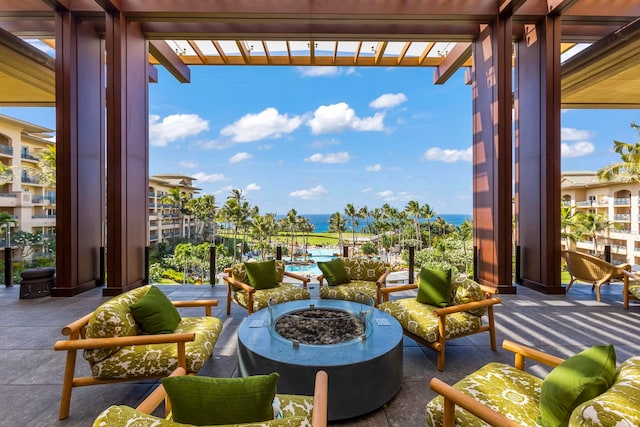 balcony with a pergola, an outdoor fire pit, and a patio area