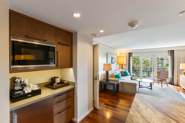 kitchen featuring french doors, stainless steel microwave, and dark wood-type flooring