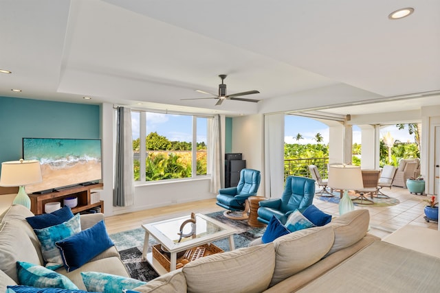 living room featuring light wood-type flooring, a wealth of natural light, and ceiling fan