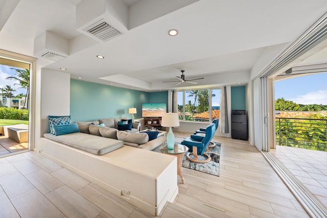 living room with light hardwood / wood-style floors and ceiling fan