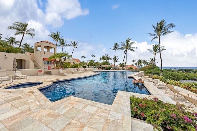 view of swimming pool with a community hot tub and a patio