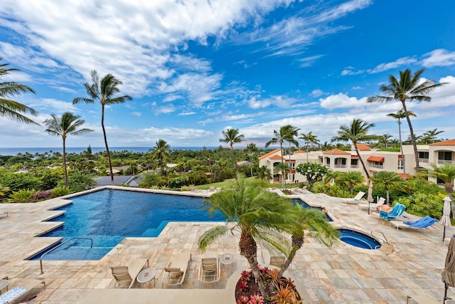 view of pool with a patio and a hot tub