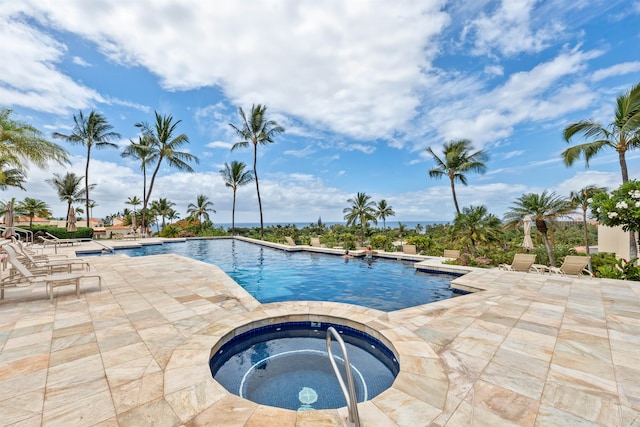 view of pool with a patio and a hot tub