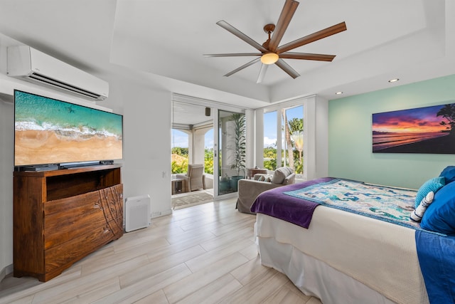 bedroom featuring access to exterior, a wall unit AC, ceiling fan, and light wood-type flooring