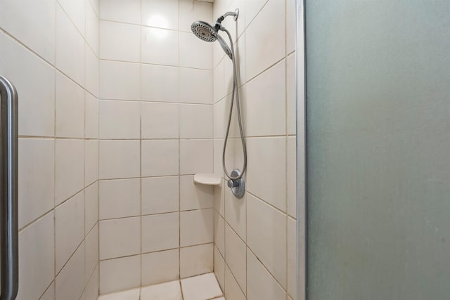 bathroom with a shower with door