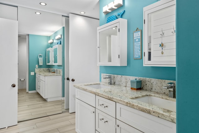 bathroom with vanity and wood-type flooring