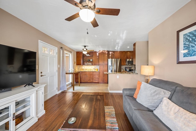 140 Uwapo Rd Unit 9-103, Kihei, HI 96753 - living room featuring a ceiling fan and light wood-style flooring