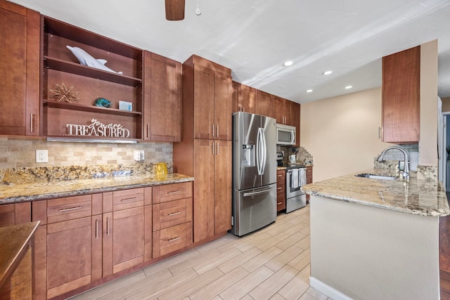 140 Uwapo Rd Unit 9-103, Kihei, HI 96753 - kitchen with stainless steel appliances, tasteful backsplash, wood finish floors, light stone countertops, and recessed lighting