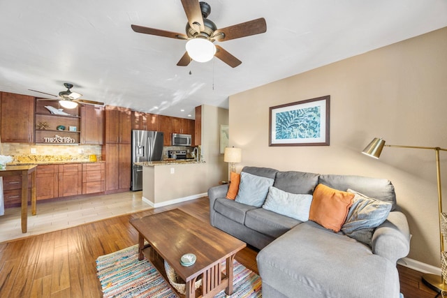 140 Uwapo Rd Unit 9-103, Kihei, HI 96753 - living room with ceiling fan and light wood-style floors