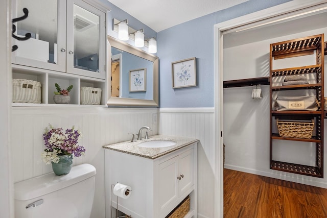140 Uwapo Rd Unit 9-103, Kihei, HI 96753 - bathroom with vanity, wood finished floors, and a wainscoted wall