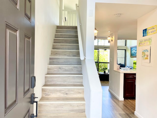 stairs with wood-type flooring