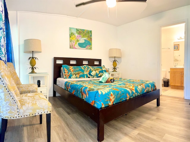 bedroom featuring connected bathroom, wood-type flooring, and ceiling fan