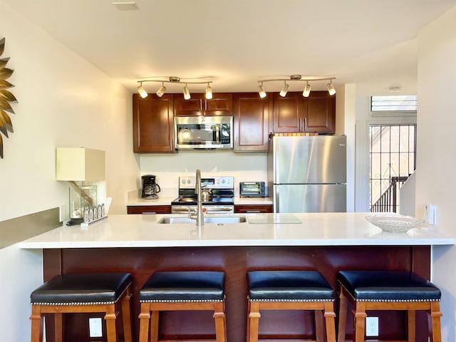 kitchen featuring a breakfast bar area, stainless steel appliances, and kitchen peninsula