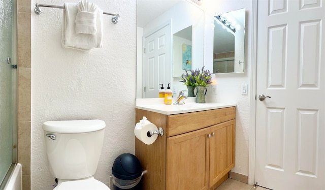 full bathroom with vanity, tile patterned flooring, combined bath / shower with glass door, and toilet