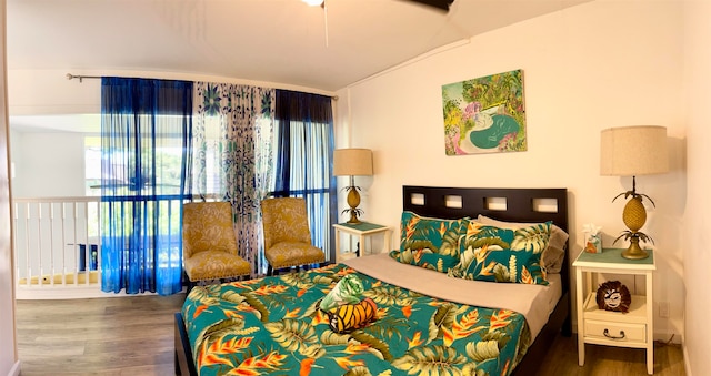 bedroom with vaulted ceiling and dark hardwood / wood-style floors