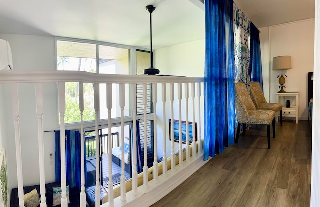 corridor with hardwood / wood-style floors and a wealth of natural light