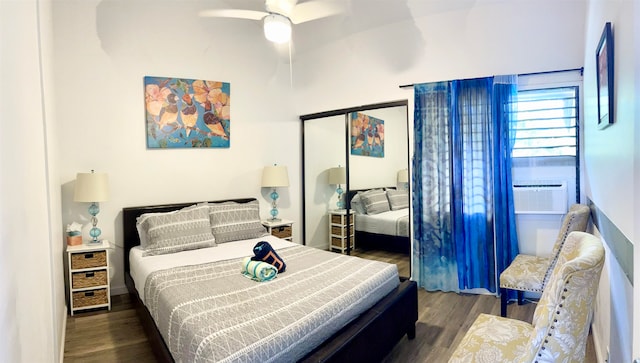 bedroom featuring ceiling fan, dark hardwood / wood-style flooring, and a closet