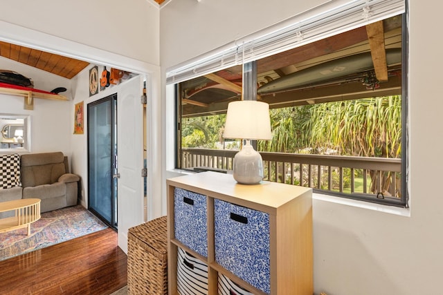 sunroom / solarium featuring vaulted ceiling and a healthy amount of sunlight