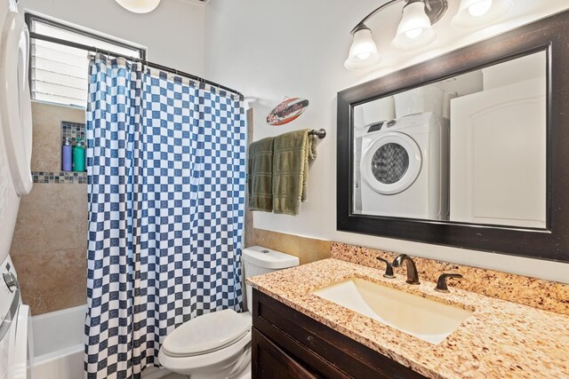 full bathroom with stacked washing maching and dryer, vanity, shower / bath combo with shower curtain, and toilet