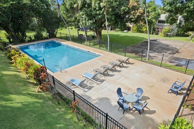 view of swimming pool with a lawn and a patio