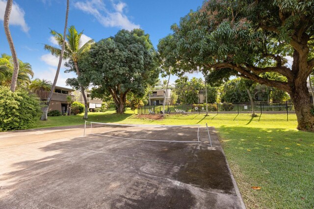 exterior space with a yard and tennis court