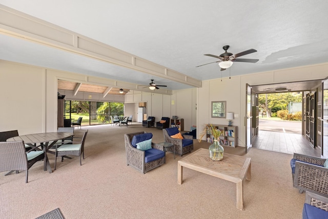 living room featuring ceiling fan and carpet flooring