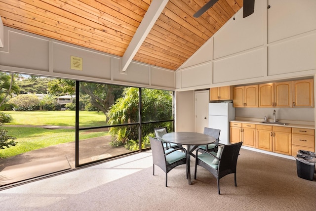 sunroom featuring wood ceiling, ceiling fan, sink, and vaulted ceiling with beams