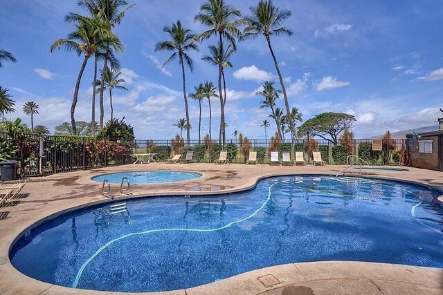 view of swimming pool featuring a community hot tub