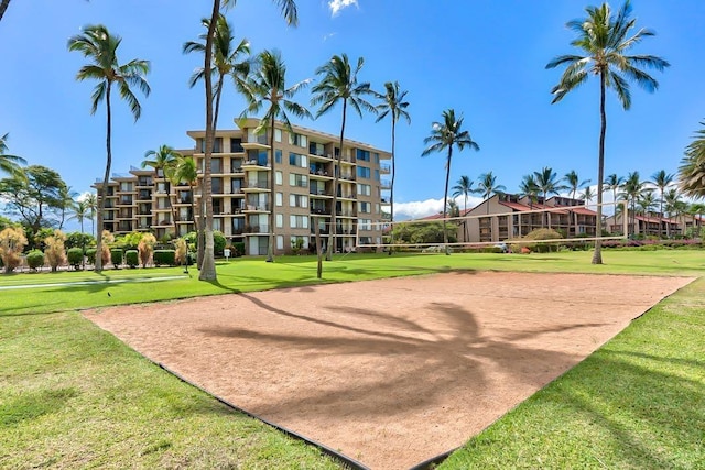 view of community featuring volleyball court and a lawn