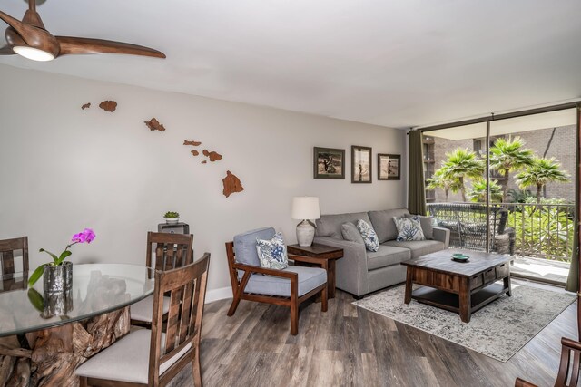 living room featuring a wall of windows and dark hardwood / wood-style floors