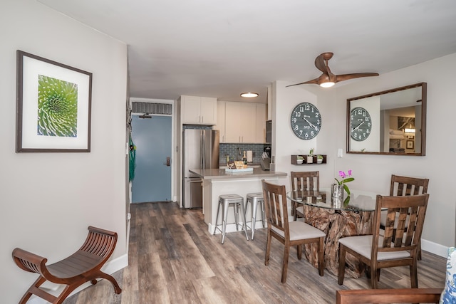 dining area featuring ceiling fan and wood-type flooring