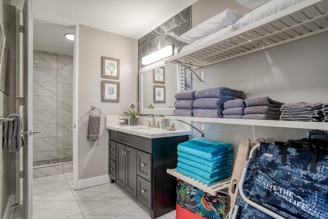 bathroom featuring a shower with door and vanity