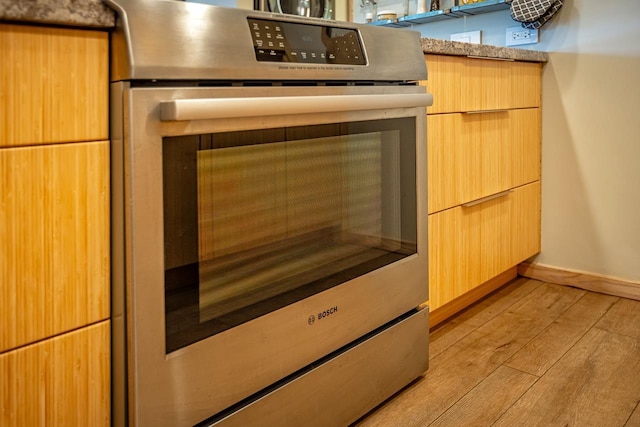 3600 Wailea Alanui Dr Unit 1101, Kihei, HI 96753 - kitchen view of stove, light wood-style floors, modern cabinets, and light brown cabinets