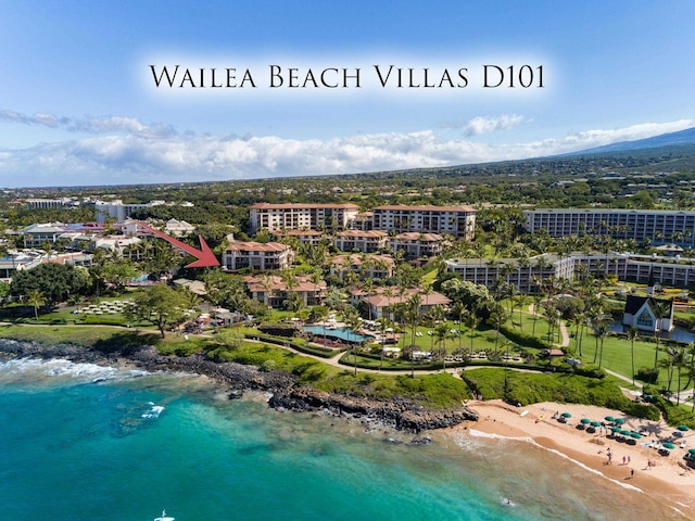 drone / aerial view with a beach view and a water view