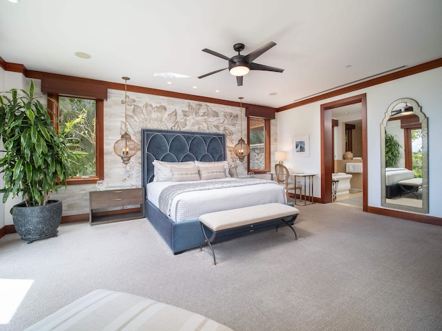 bedroom with a stone fireplace, multiple windows, ceiling fan, and ensuite bath