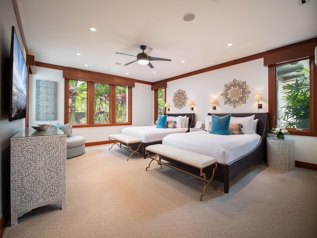 bedroom featuring ceiling fan, crown molding, and carpet floors