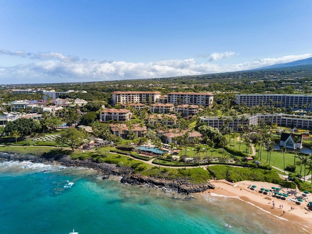 drone / aerial view featuring a beach view and a water view