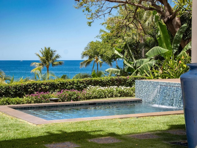 exterior space featuring a lawn and a water view