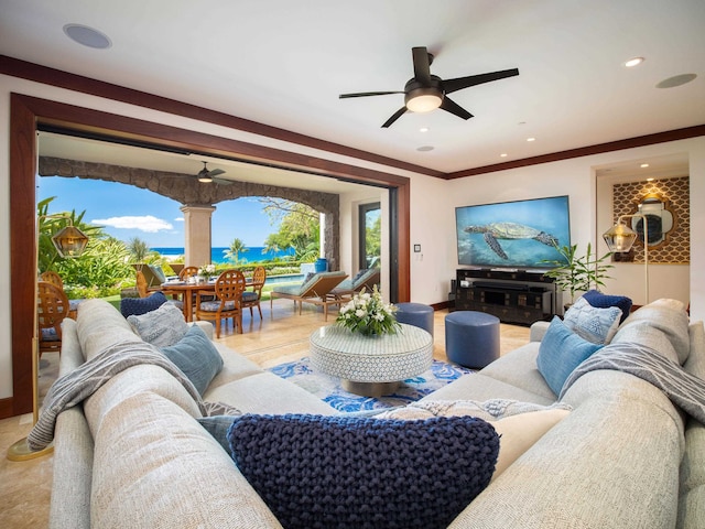 living room featuring ceiling fan and ornamental molding